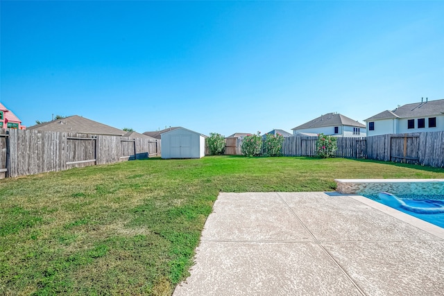 view of yard featuring a storage shed, a patio area, and a covered pool