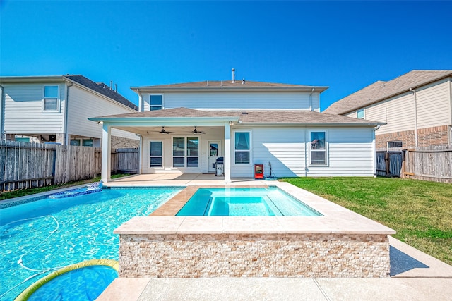 view of pool featuring ceiling fan, a yard, a patio, a grill, and a jacuzzi