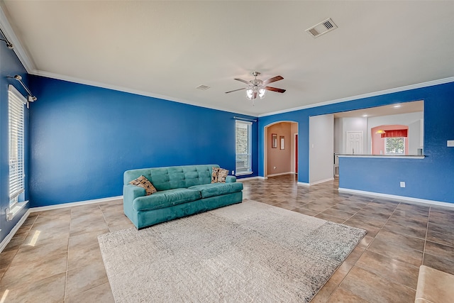 living room with light tile patterned floors, ornamental molding, and ceiling fan