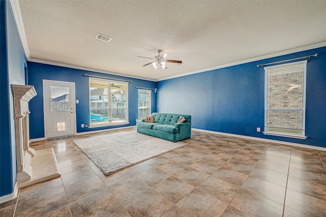 unfurnished room with ceiling fan, ornamental molding, and a textured ceiling