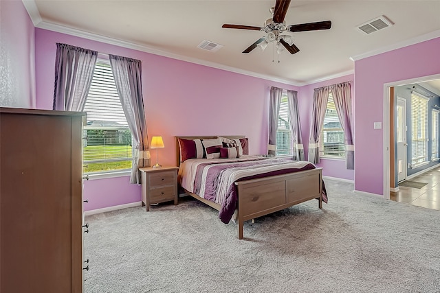 bedroom featuring multiple windows, ornamental molding, light colored carpet, and ceiling fan