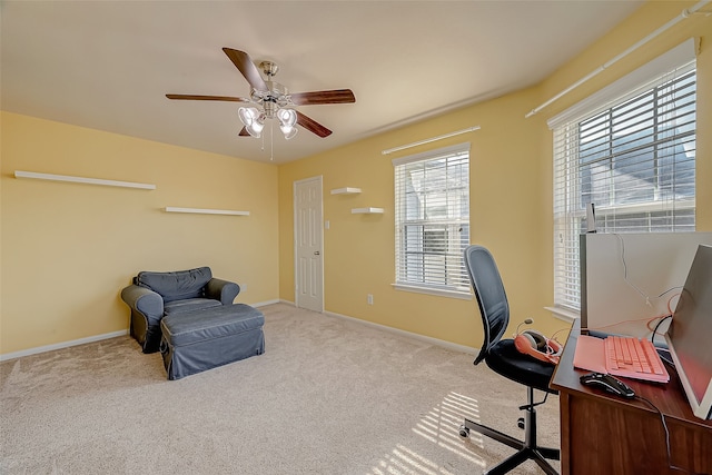 office space featuring light carpet and ceiling fan