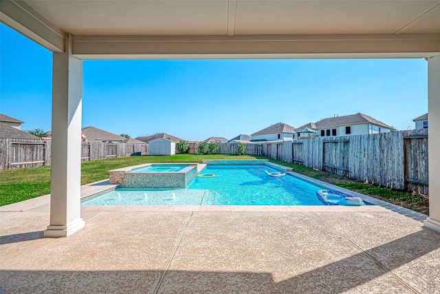 view of swimming pool featuring an in ground hot tub, a storage unit, and a patio area