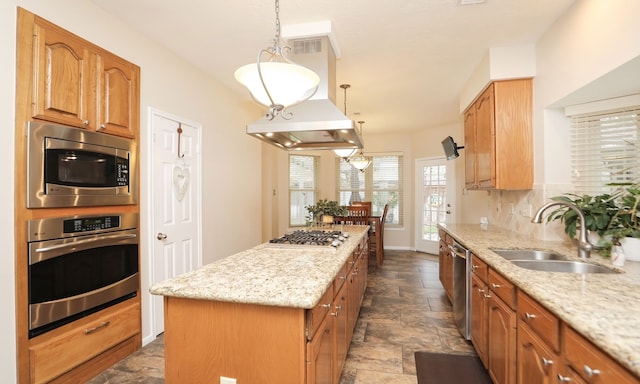 kitchen featuring sink, hanging light fixtures, a center island, and appliances with stainless steel finishes