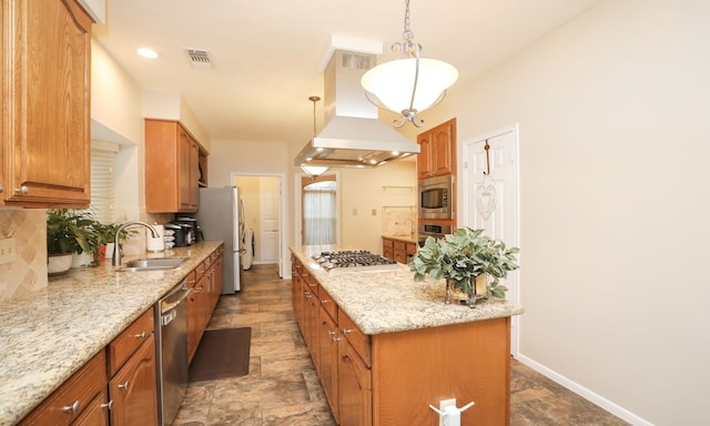 kitchen with sink, light stone counters, island range hood, hanging light fixtures, and stainless steel appliances