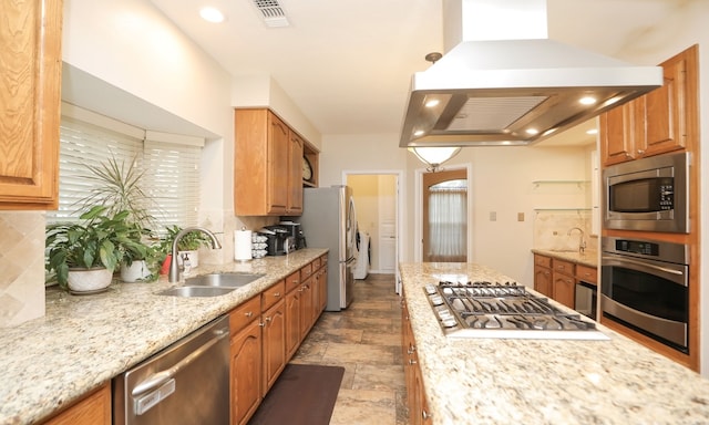 kitchen with sink, decorative backsplash, stainless steel appliances, and island exhaust hood