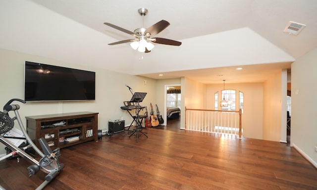 exercise area with dark hardwood / wood-style floors and ceiling fan