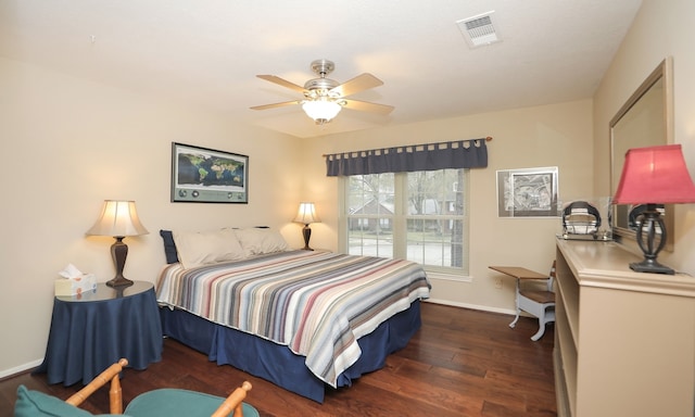 bedroom with dark hardwood / wood-style flooring and ceiling fan