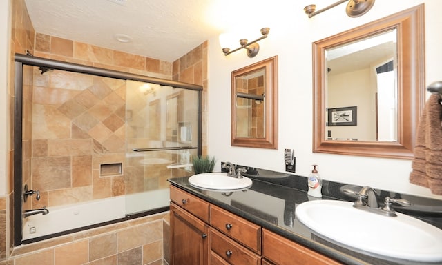 bathroom featuring vanity and combined bath / shower with glass door