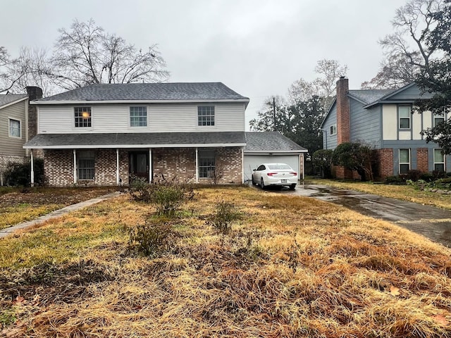 front facade with a garage and a front yard