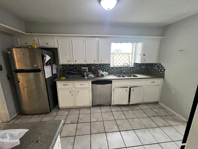 kitchen with white cabinetry, appliances with stainless steel finishes, sink, and light tile patterned floors