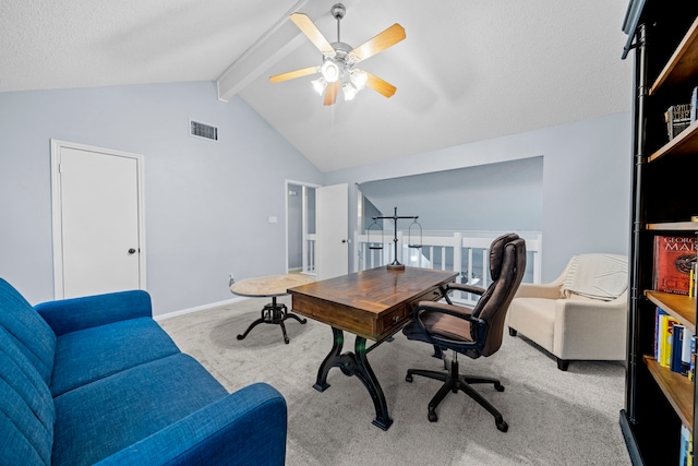 carpeted home office featuring lofted ceiling with beams, ceiling fan, and a textured ceiling