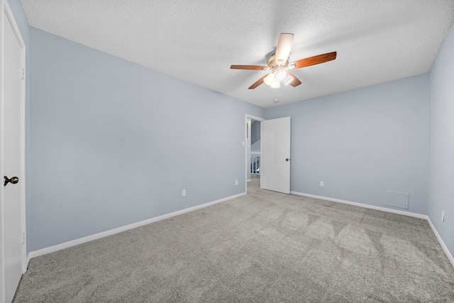 unfurnished room featuring light carpet, ceiling fan, and a textured ceiling