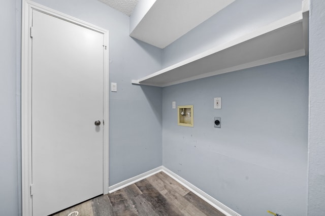 clothes washing area featuring hookup for a washing machine, hardwood / wood-style floors, hookup for an electric dryer, and a textured ceiling