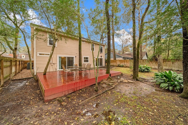 rear view of house featuring a deck