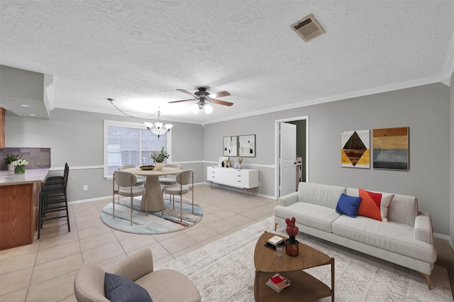 living room with light tile patterned floors, crown molding, ceiling fan with notable chandelier, and a textured ceiling