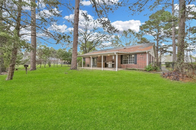 rear view of property featuring a yard and a patio