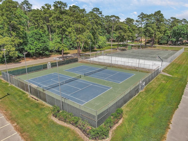 view of sport court with a lawn