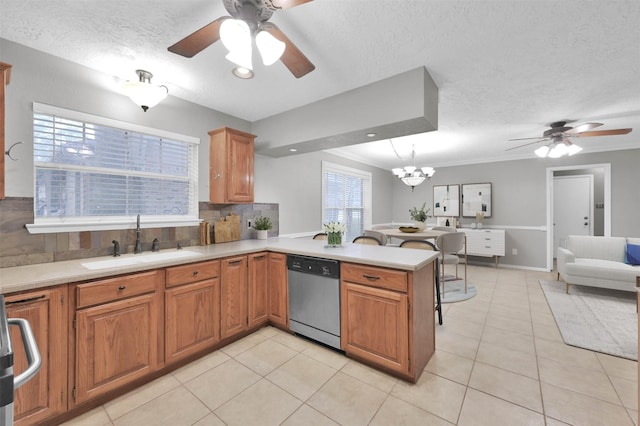 kitchen featuring sink, dishwasher, a textured ceiling, light tile patterned flooring, and kitchen peninsula