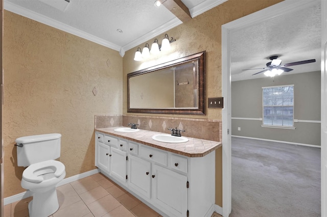 bathroom with crown molding, tasteful backsplash, vanity, and a textured ceiling