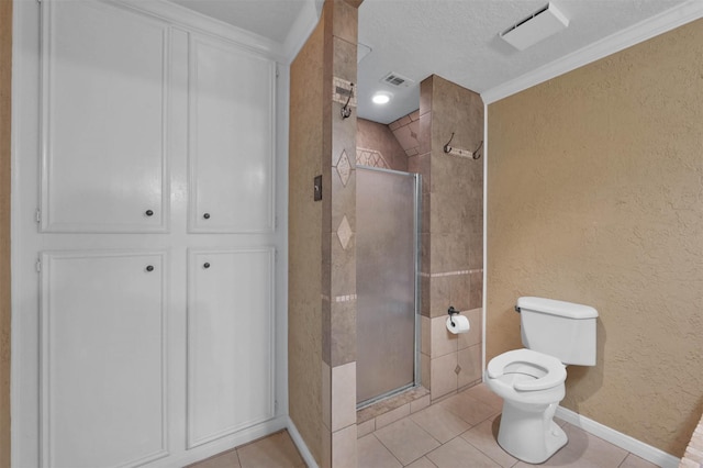 bathroom featuring tile patterned flooring, crown molding, a shower with shower door, and toilet