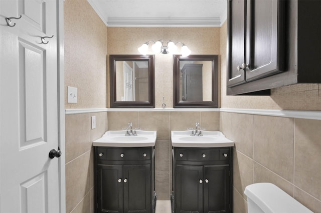 bathroom featuring tile walls, vanity, ornamental molding, and toilet