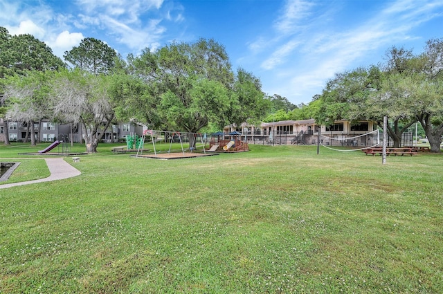 view of property's community with a playground and a lawn