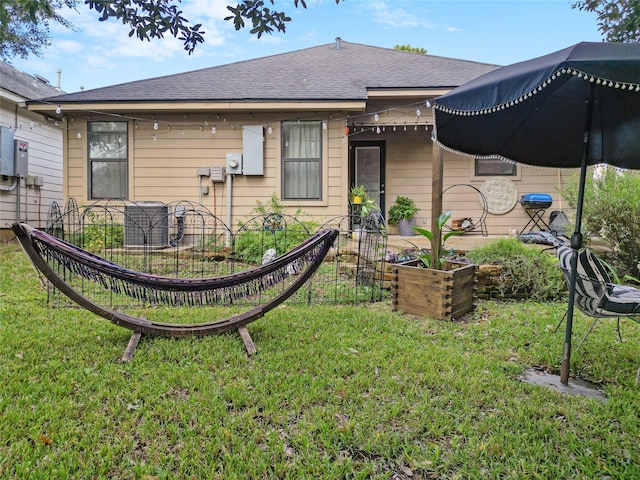 rear view of house with a yard