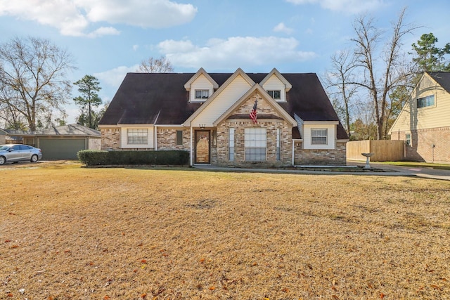 view of front of house with a front yard and fence