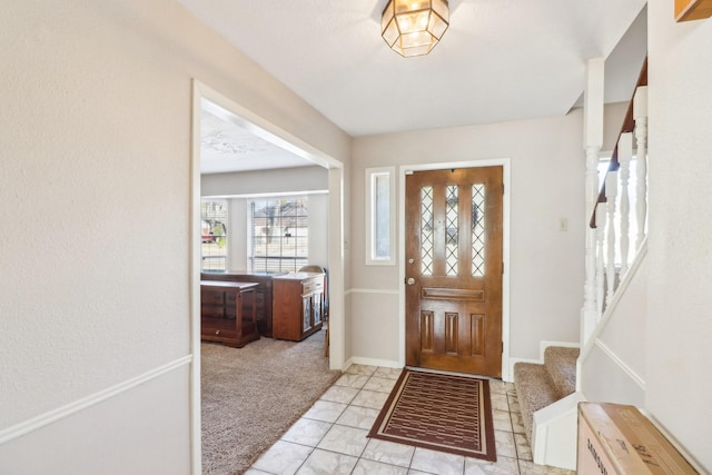 entryway with light colored carpet