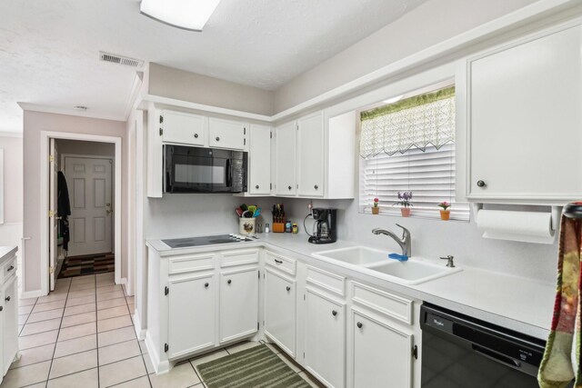 kitchen with white cabinetry, sink, light tile patterned floors, and black appliances