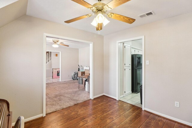 interior space with wood-type flooring and ceiling fan