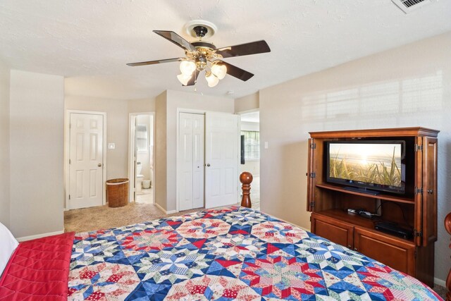 carpeted bedroom with ceiling fan, ensuite bathroom, a closet, and a textured ceiling