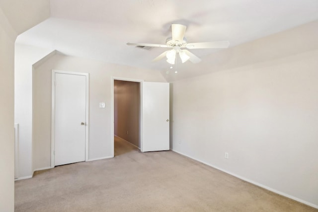 unfurnished bedroom featuring light colored carpet and ceiling fan