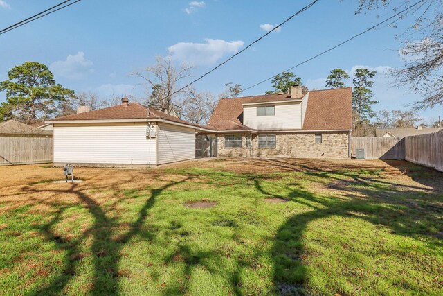 back of property featuring a yard