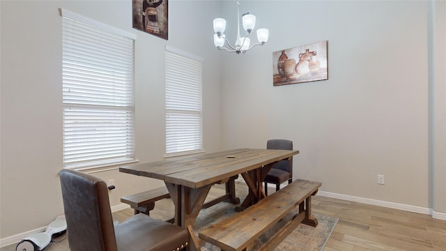 dining room with an inviting chandelier and light wood-type flooring