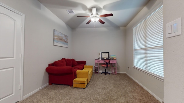 living area featuring ceiling fan and light carpet