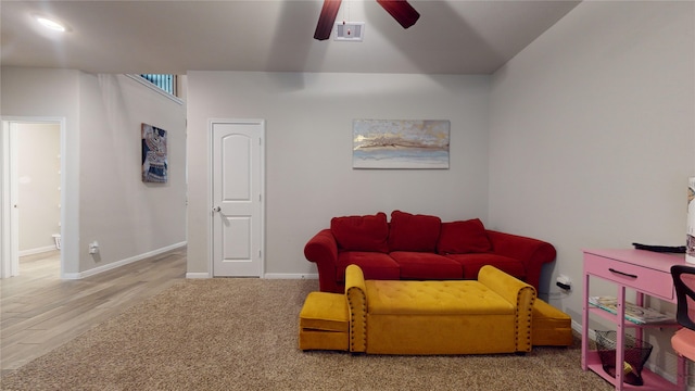 living room with hardwood / wood-style flooring and ceiling fan