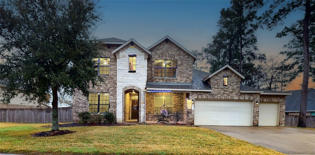 view of front of property featuring a garage and a lawn