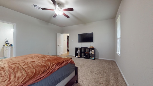 bedroom with light carpet, ceiling fan, and ensuite bath