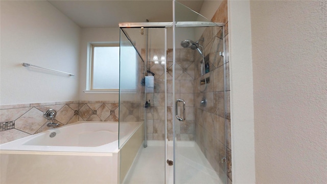 bathroom featuring separate shower and tub