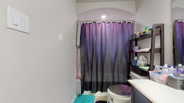 full bathroom featuring toilet, tile patterned floors, vanity, and shower / bathtub combination with curtain