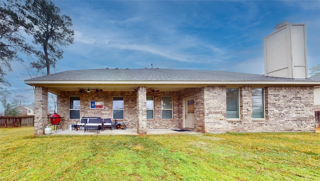 rear view of property featuring an outdoor hangout area, a patio area, ceiling fan, and a lawn