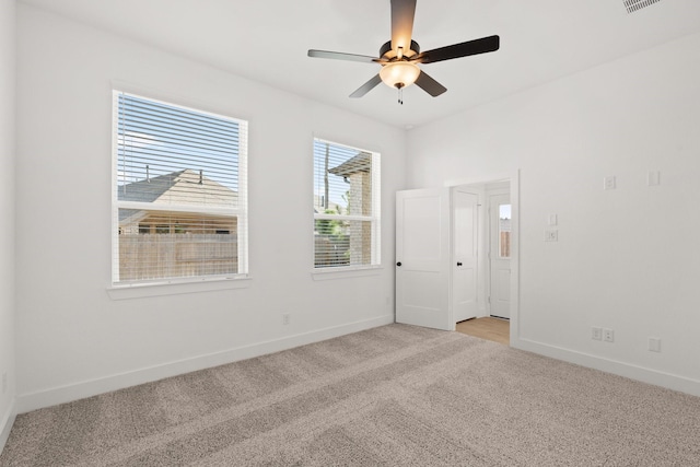 empty room with light carpet and ceiling fan