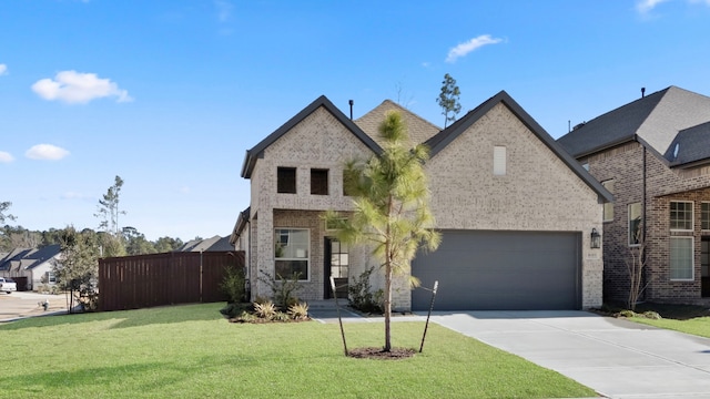 french country inspired facade featuring a garage and a front yard