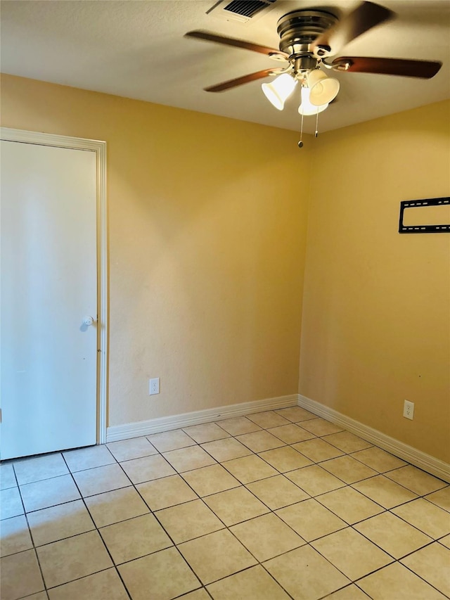 unfurnished room with light tile patterned flooring and ceiling fan