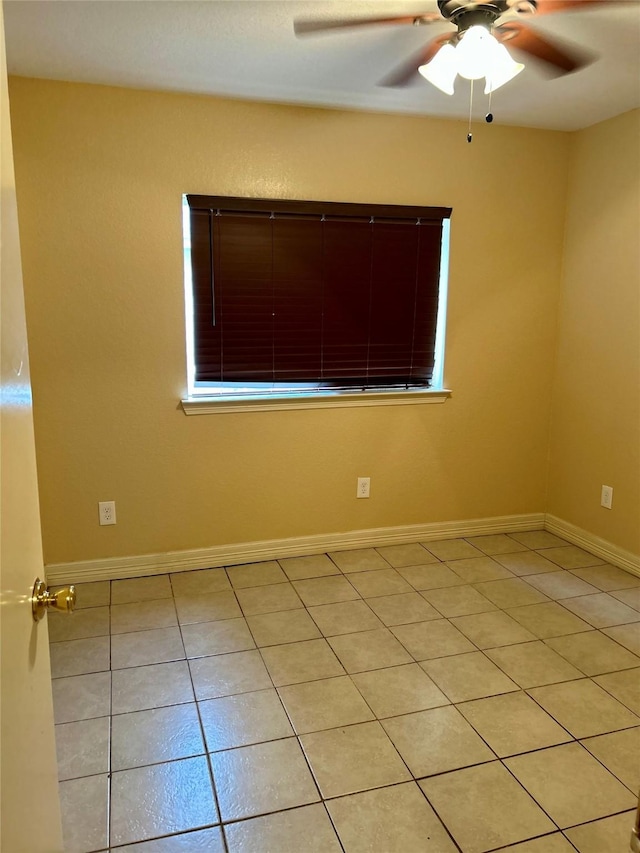 empty room with light tile patterned flooring and ceiling fan