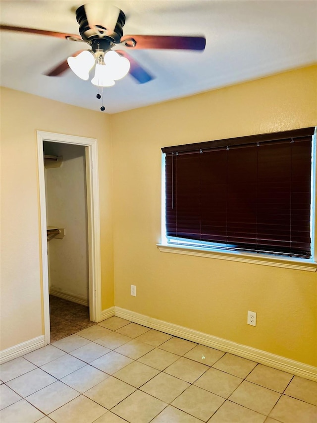 unfurnished bedroom with light tile patterned flooring and ceiling fan