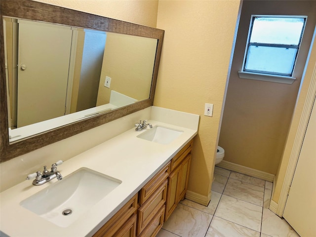 bathroom featuring vanity and toilet