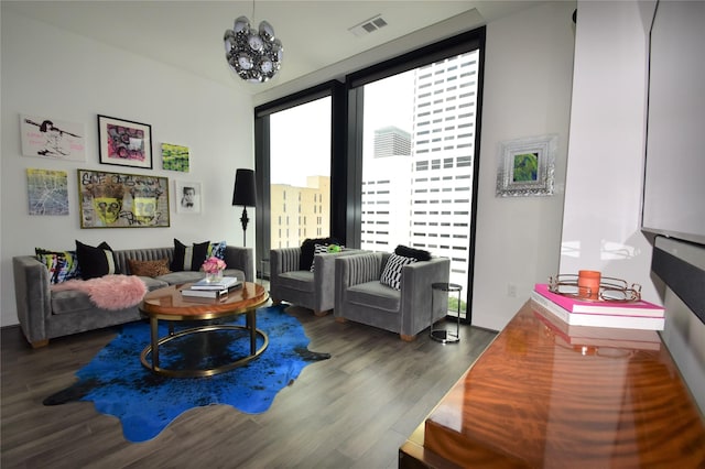 living room with expansive windows, dark hardwood / wood-style floors, and a notable chandelier